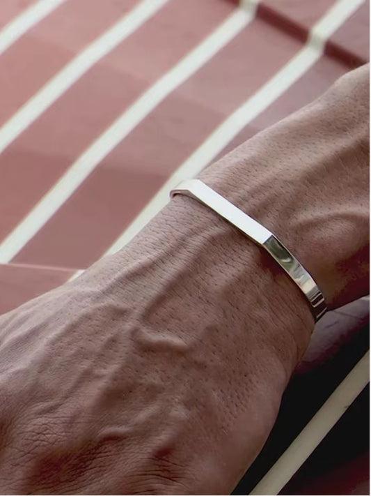 Minimalist silver stainless steel bracelet with polished finish, waterproof and unisex design. Perfect for daily wear and sports.