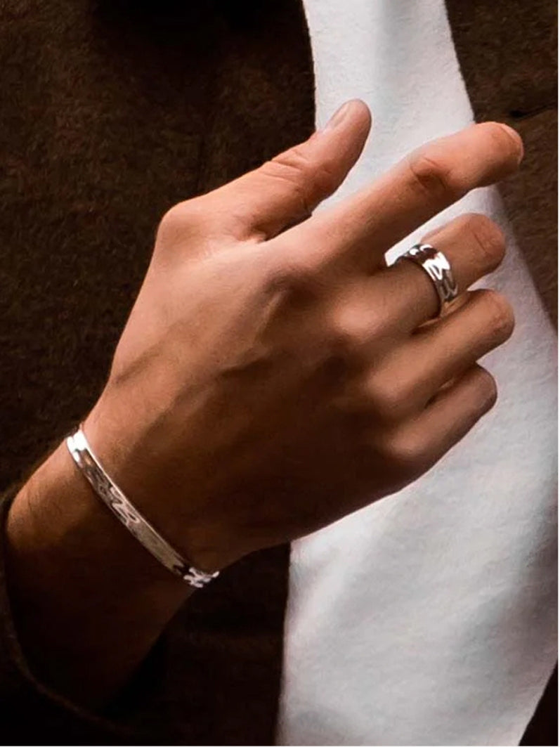 Stylish men’s jewelry set featuring a textured gold ring and a matching textured bracelet